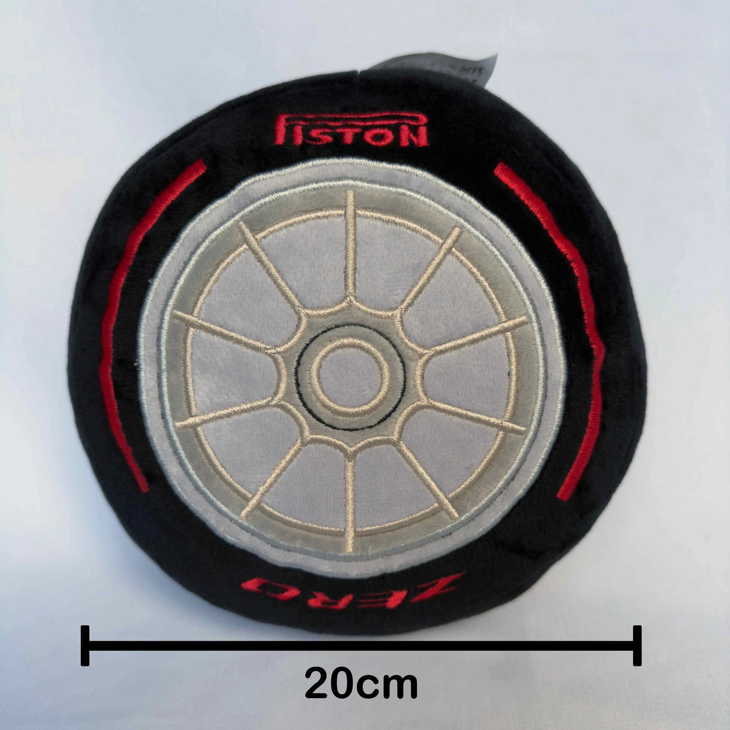 Formula 1 Race Tire Plush Toy cushion pillow shown on white background with measurement showing a diameter of 20cm