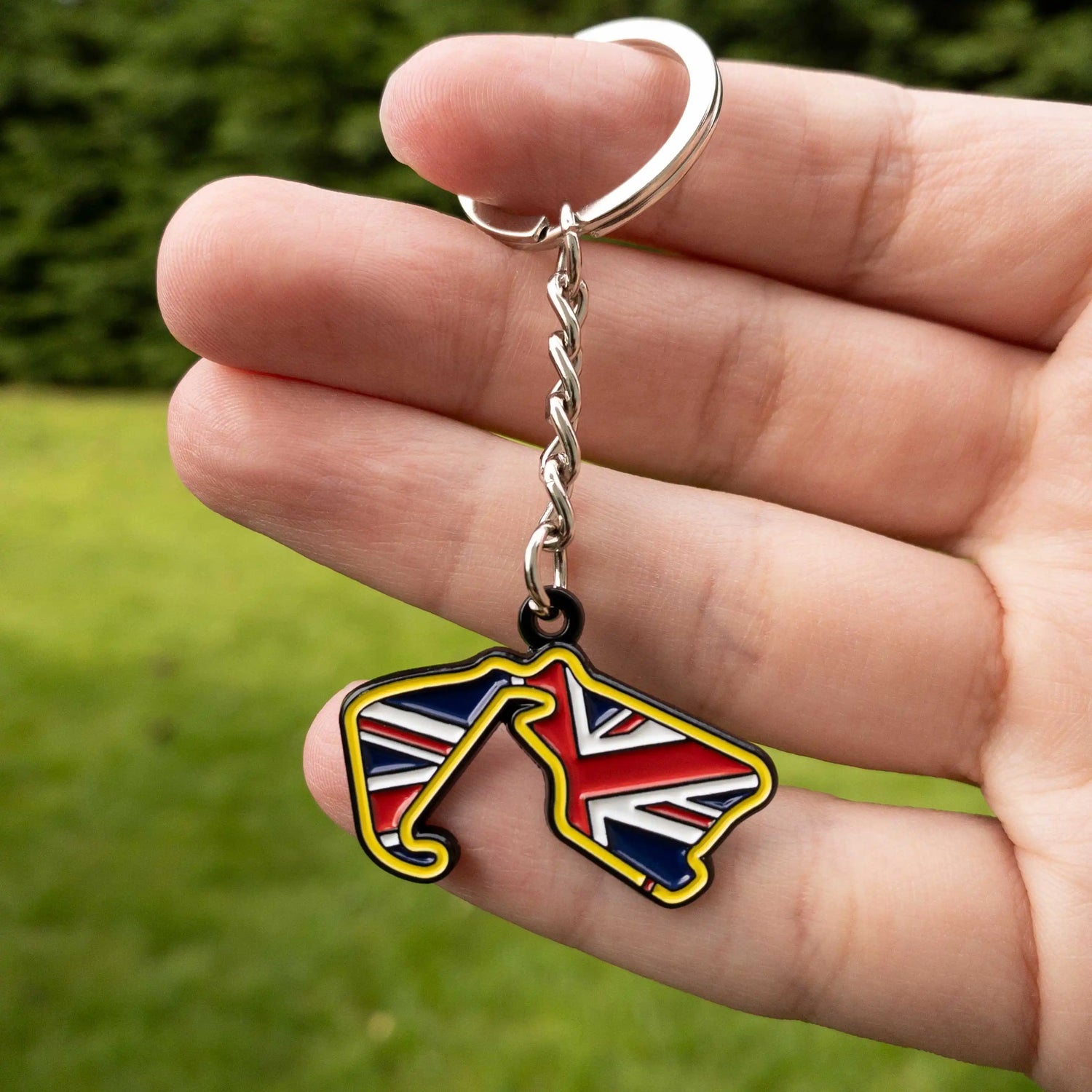 Silverstone Circuit Enamel Keychain shown on hand