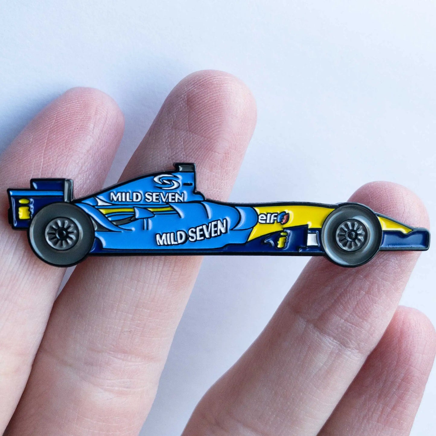 Renault R26 Formula One Car Enamel Pin shown on hand