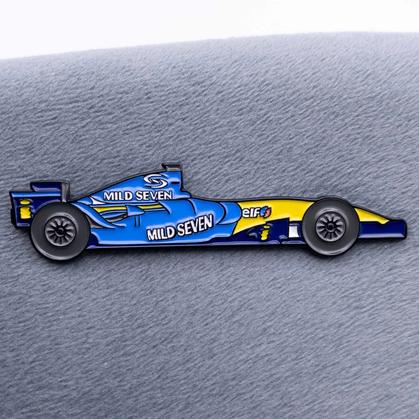 Renault R26 Formula One Car Enamel Pin shown on grey cloth