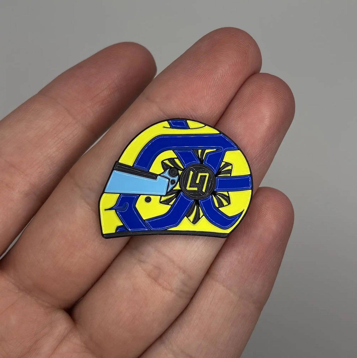 Lando Norris 2022 Helmet Enamel Pin shown on hand