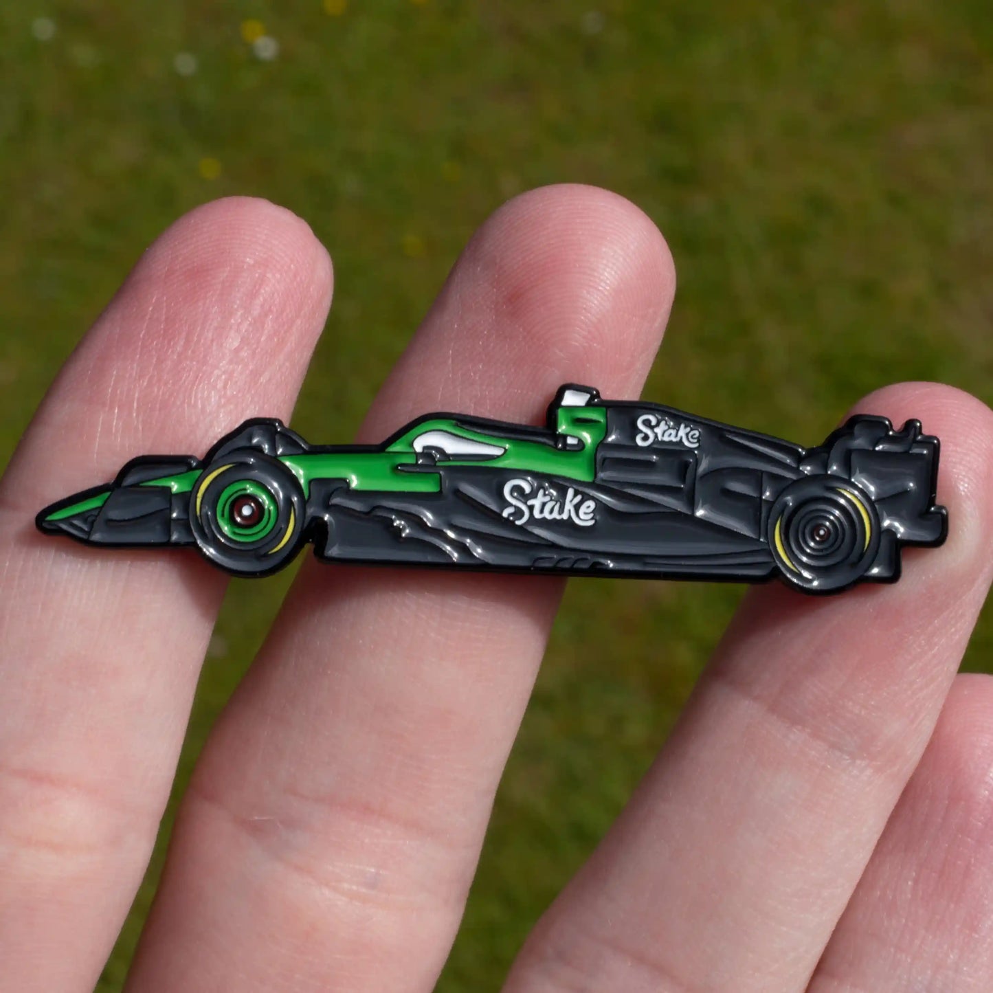 Kick Sauber C45 Formula One Car Enamel Pin shown on hand