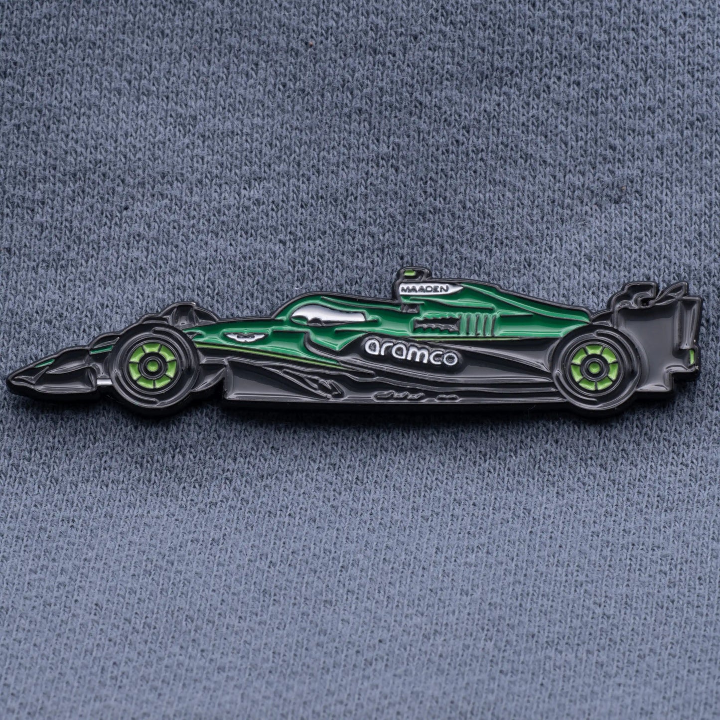 Aston Martin AMR25 Formula One Car Enamel Pin shown on grey cloth