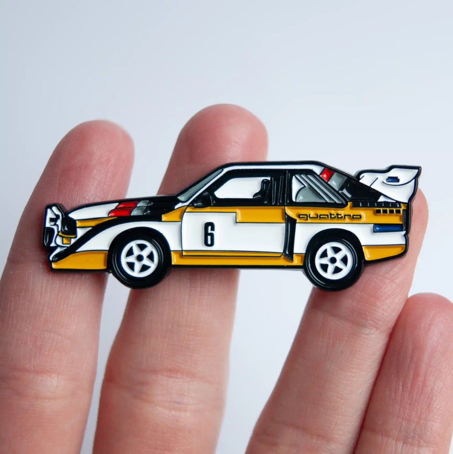 Audi Sport Quattro S1 E2 Rally Car Enamel Pin shown on hand