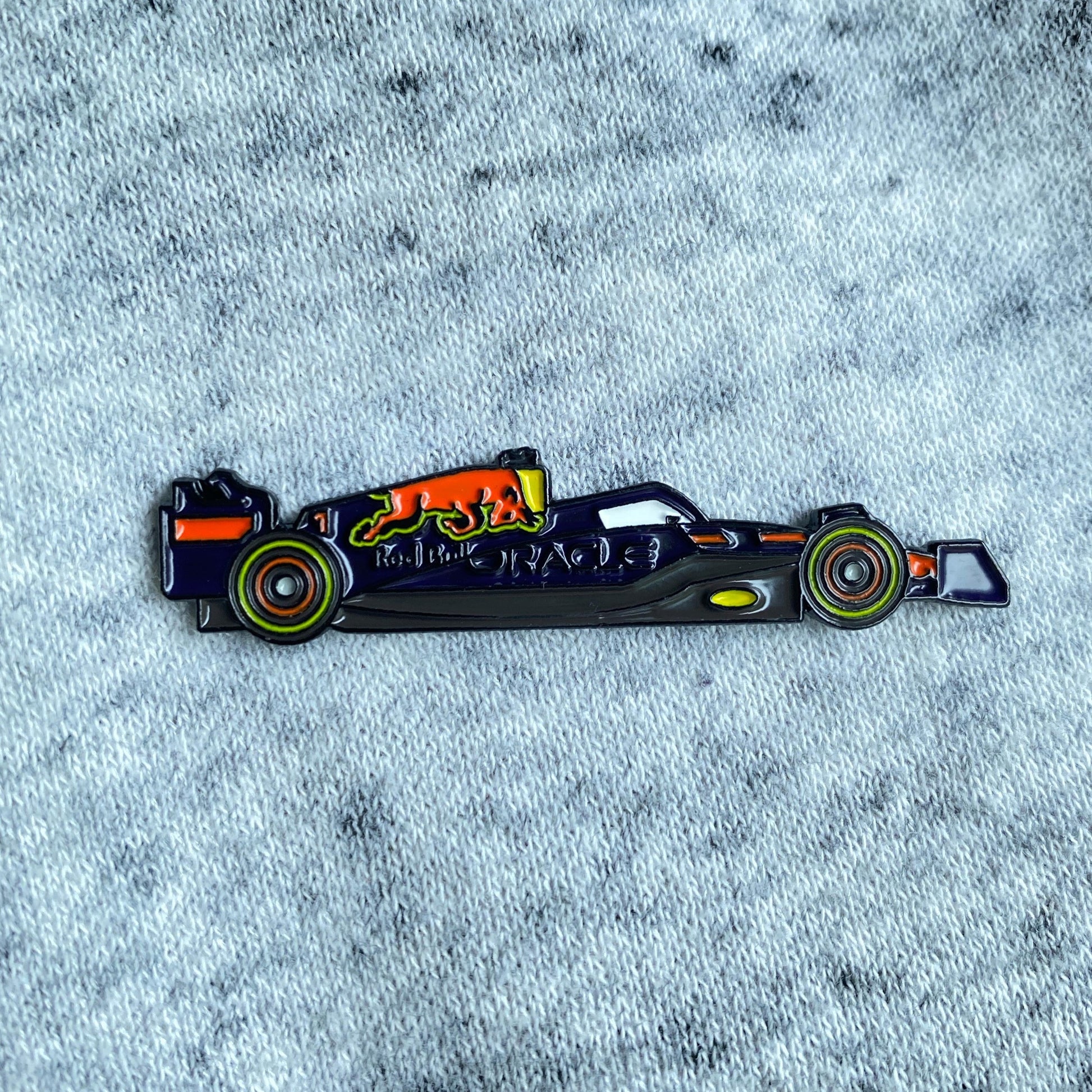 Red Bull RB18 Formula One Enamel Pin shown on cloth