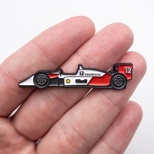 McLaren MP4/4 Formula One Car Enamel Pin shown on hand