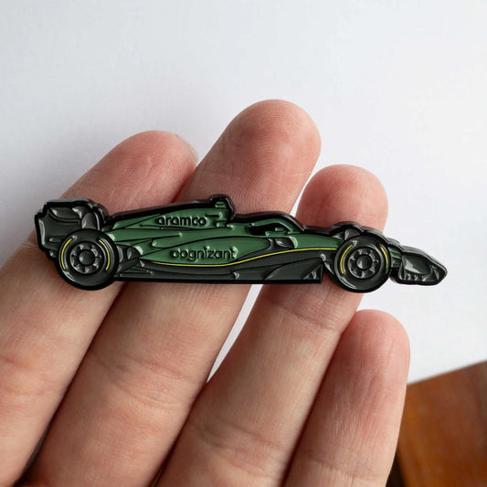 Aston Martin AMR23 Formula One Car Enamel Pin shown on hand