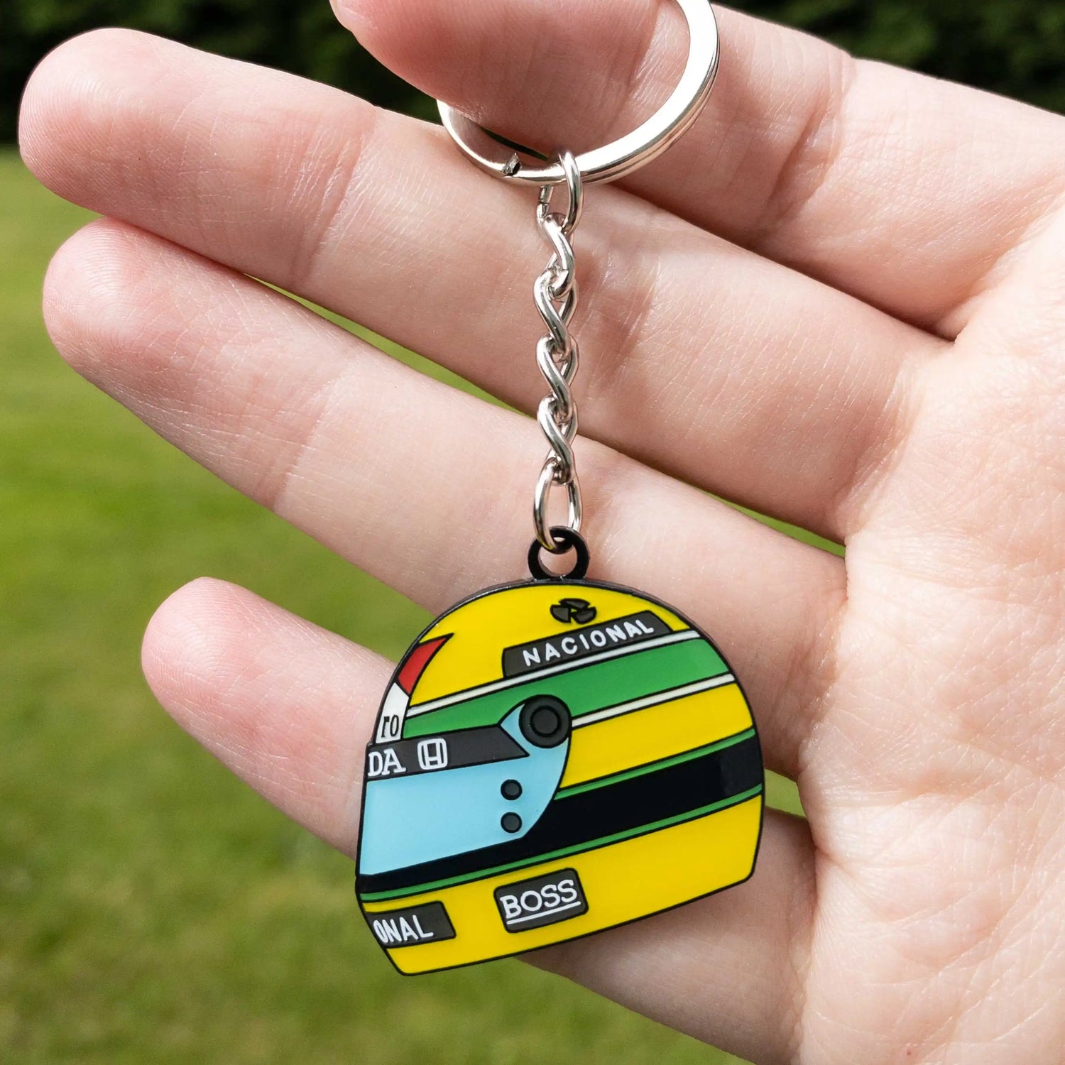 Ayrton Senna 1988 Helmet Enamel Keychain shown on hand