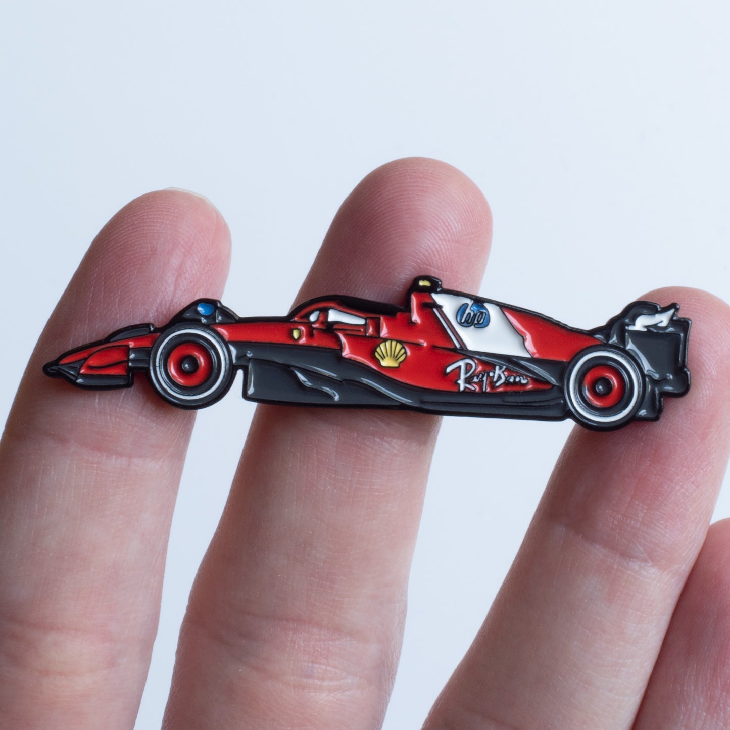 Ferrari SF-25 Formula One Car Enamel Pin shown on hand