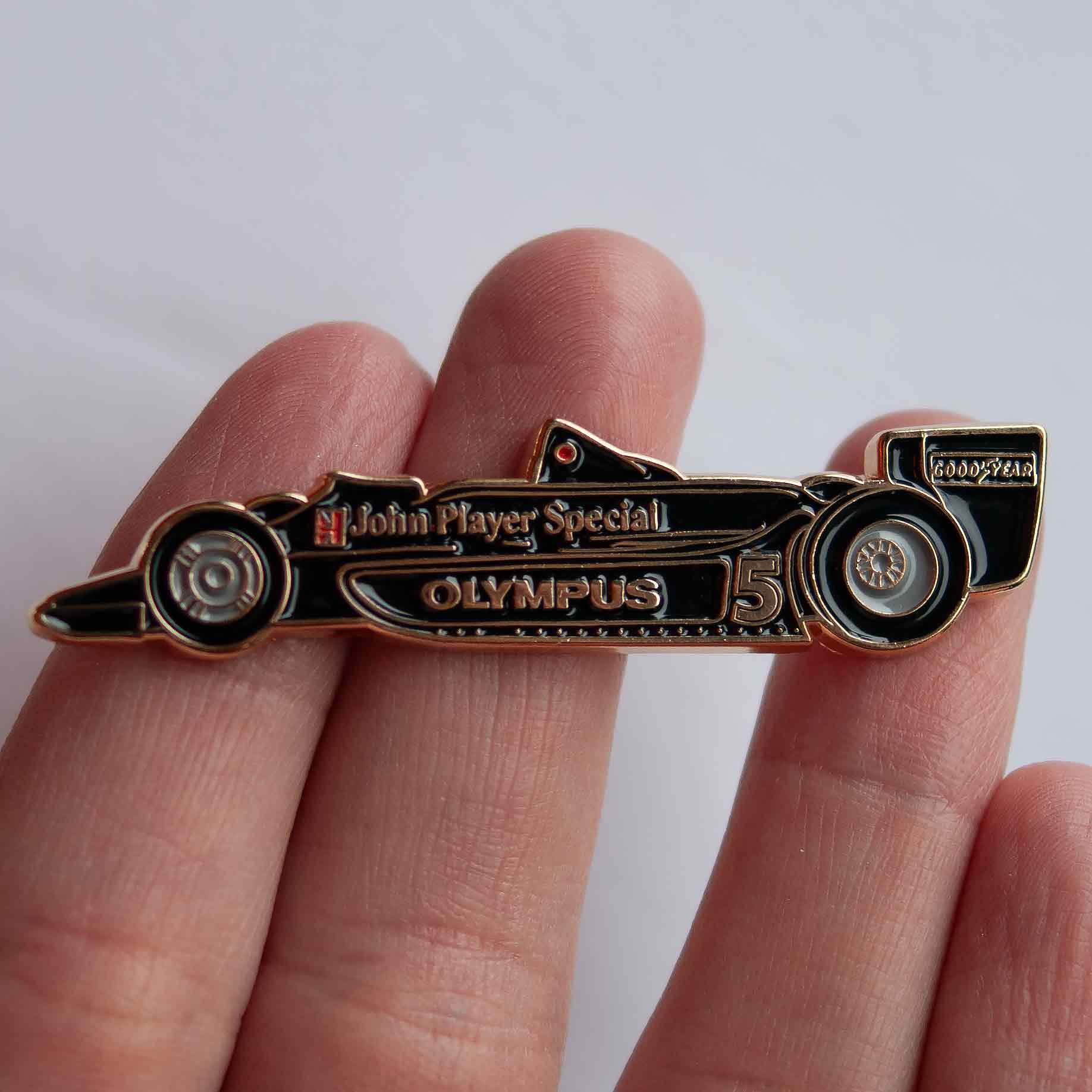 Lotus 79 Formula One Car Enamel Pin shown on hand