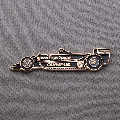 Lotus 79 Formula One Car Enamel Pin shown on grey cloth