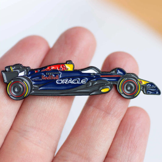 Red Bull RB20 Formula One Car Enamel Pin Badge shown on hand
