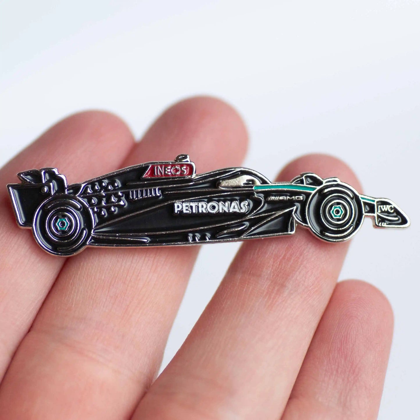 Mercedes W15 Formula One Car Enamel Pin Badge shown on hand