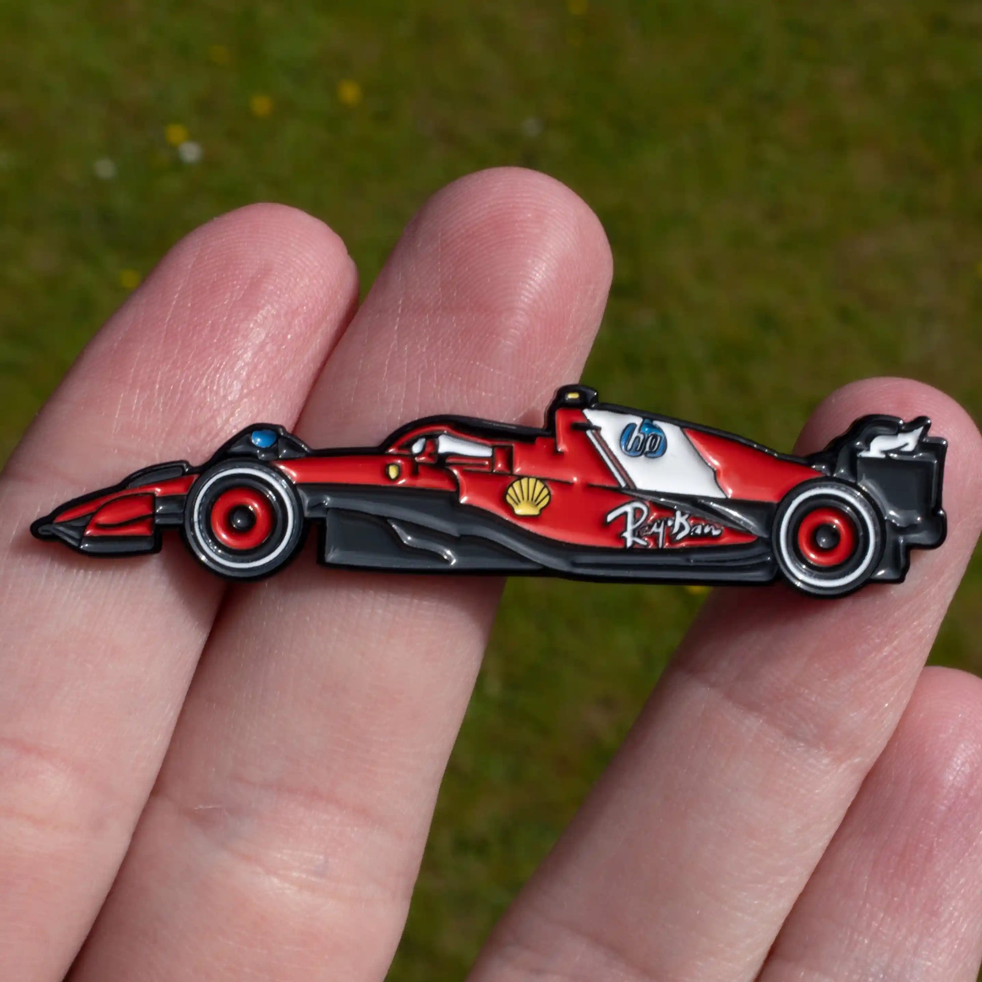 Ferrari SF-25 Formula One Car Enamel Pin shown on hand