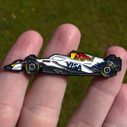 Racing Bulls VCARB 02 Formula One Car Enamel Pin shown on hand