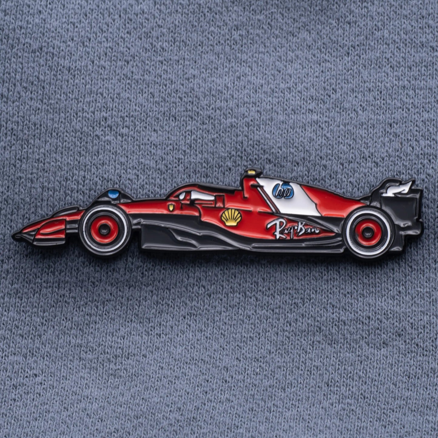 Ferrari SF-25 Formula One Car Enamel Pin shown on grey cloth