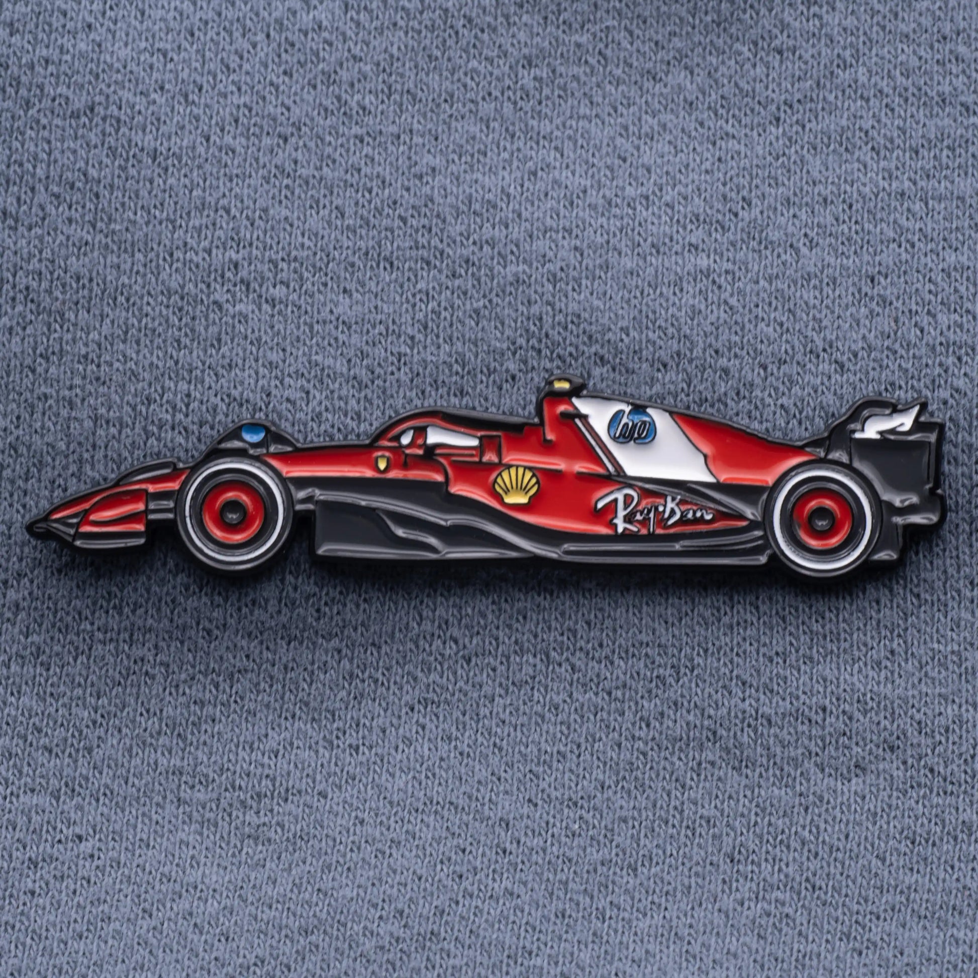 Ferrari SF-25 Formula One Car Enamel Pin shown on grey cloth