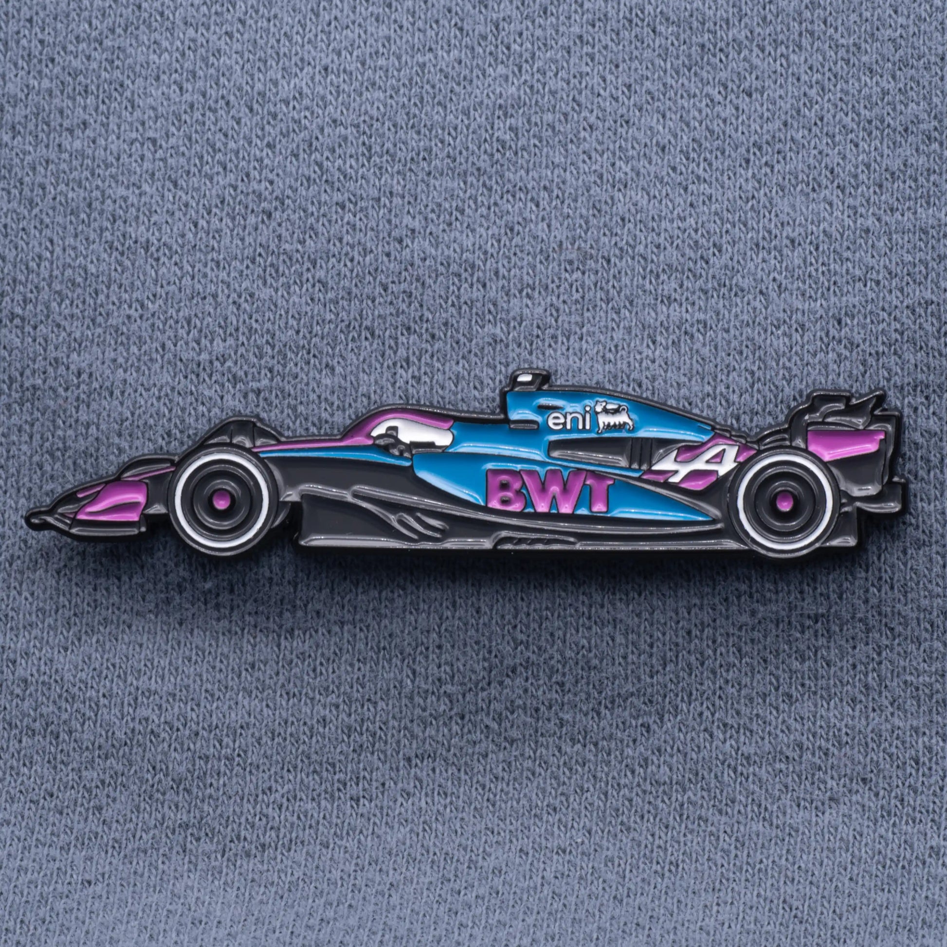 Alpine A525 Formula One Car Enamel Pin shown on grey cloth
