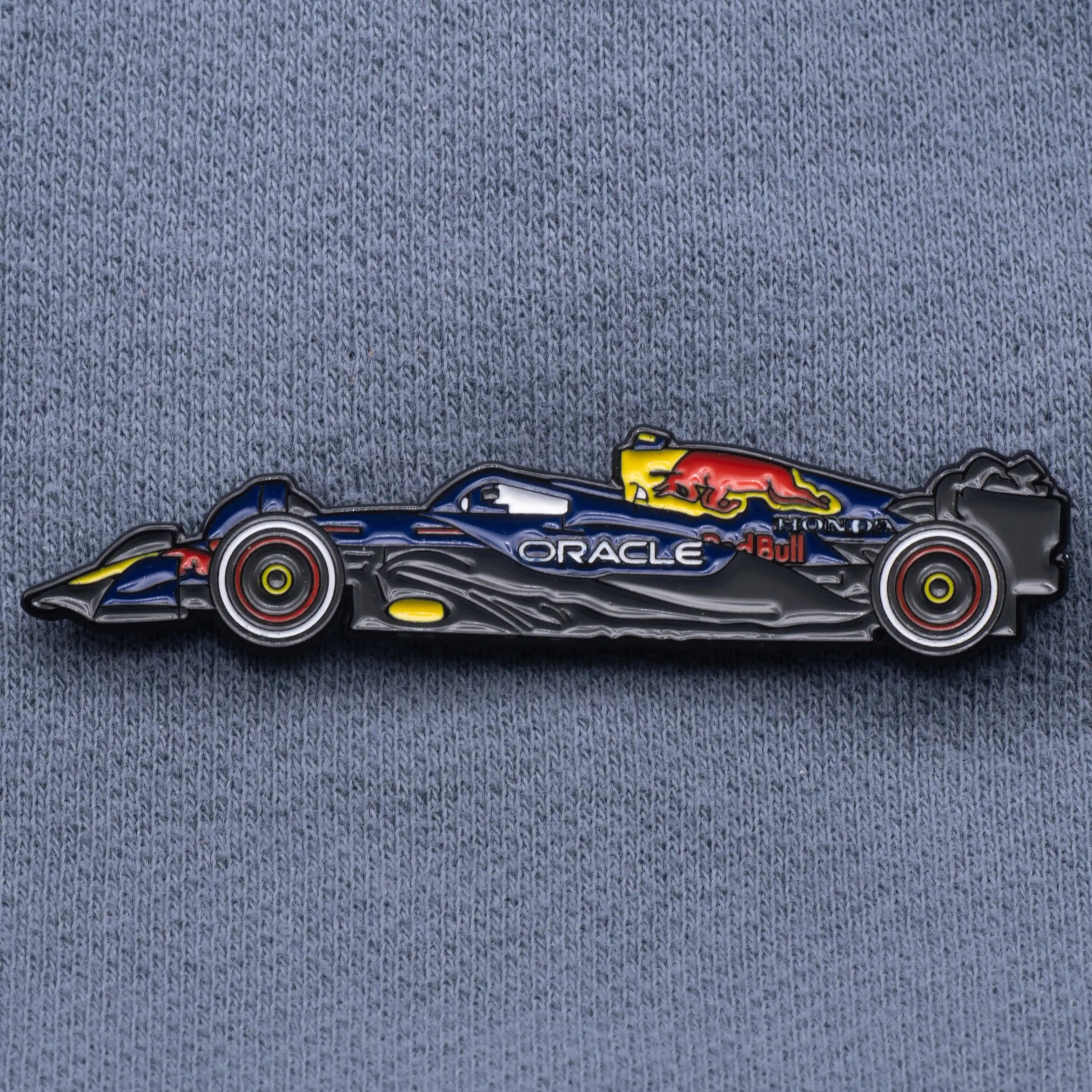 Red Bull RB21 Formula One Car Enamel Pin shown on grey cloth