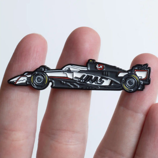Haas VF-25 Formula One Car Enamel Pin shown on hand