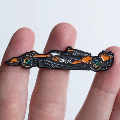McLaren MCL39 Formula One Car Enamel Pin shown on hand