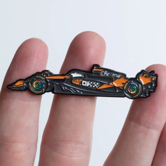 McLaren MCL39 Formula One Car Enamel Pin shown on hand
