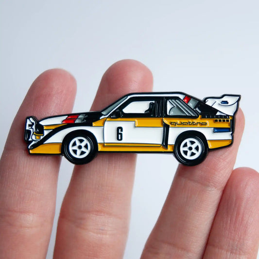 Audi Sport Quattro S1 E2 Rally Car Enamel Pin shown on hand