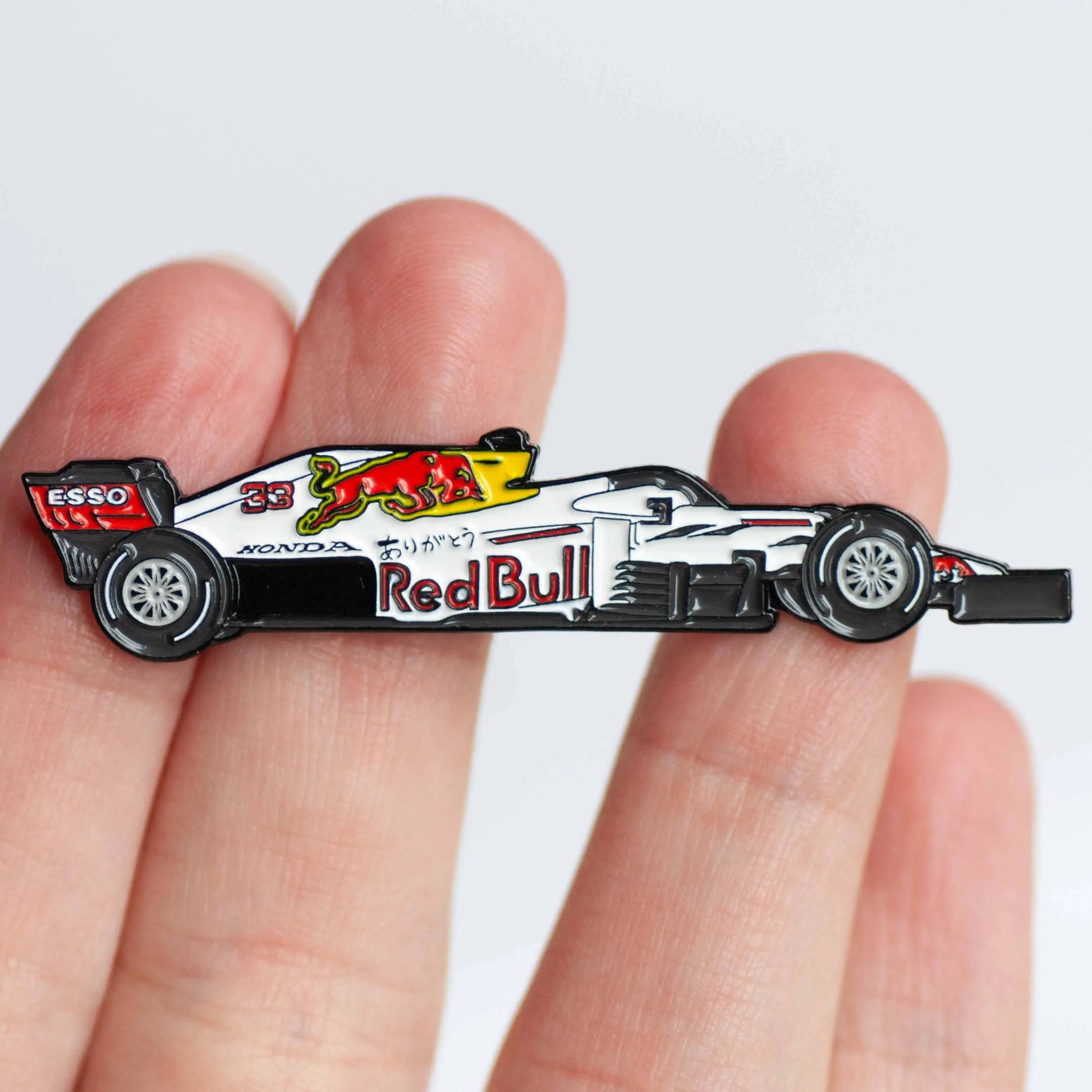 Red Bull RB16B "Arigatou" Livery Formula One Car Enamel Pin shown on hand