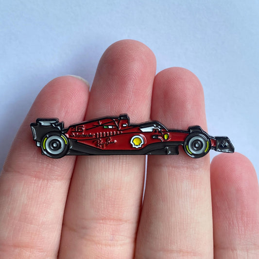 Ferrari F1-75 Formula One Car Enamel Pin shown on hand